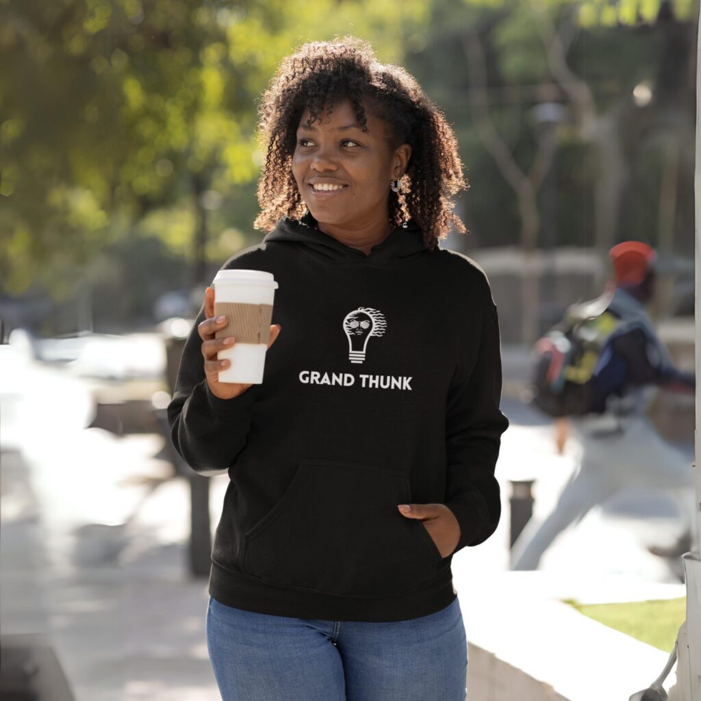 Woman wearing black Grand Thunk pullover hoodie.