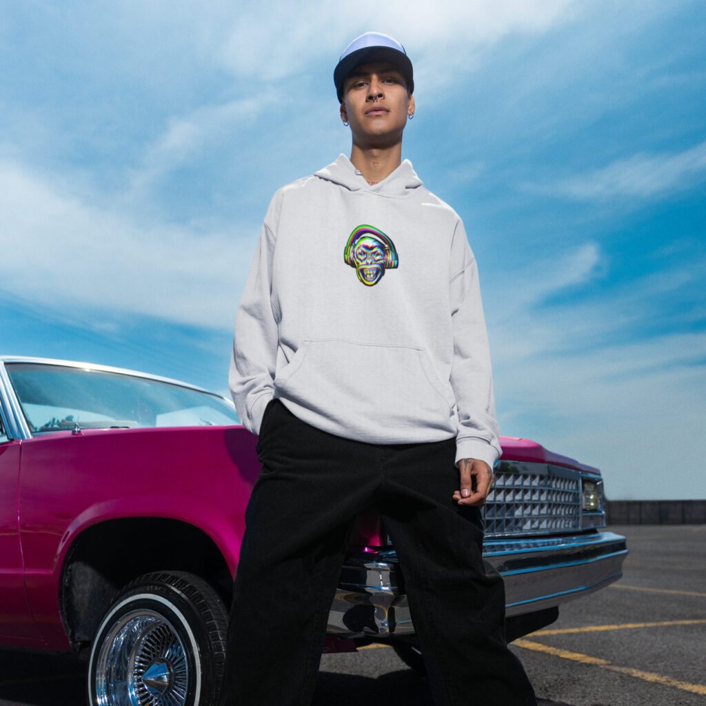 Man wearing Monkeyhead pullover hoodie in front of lowrider car