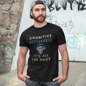 Cognitive Dissonance All The Rage t-shirt worn by a man against a graffiti wall.
