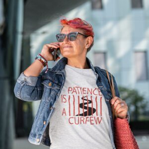 Patience Is A Curfew t-shirt worn by a mature woman.