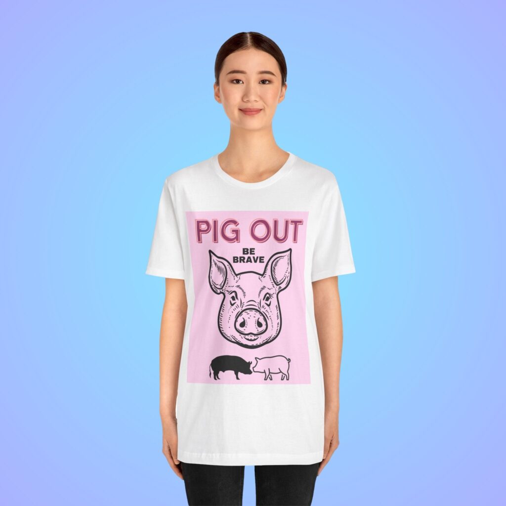 Pig Out Be Brave Pink t-shirt worn by a woman.