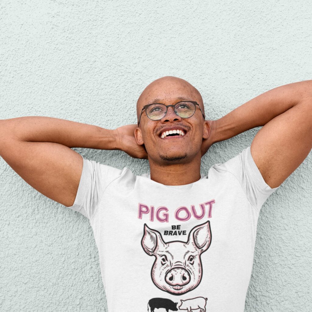 Pig Out Be Brave t-shirt worn by a man.
